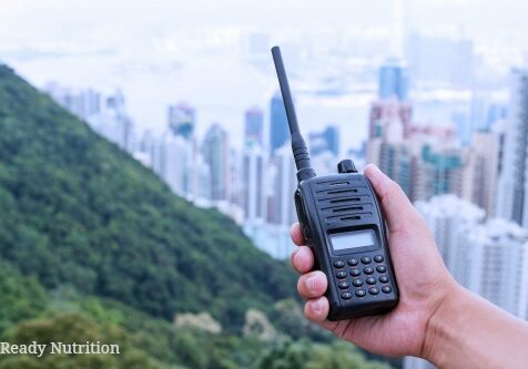 hand holding walky talky with cityscape as background