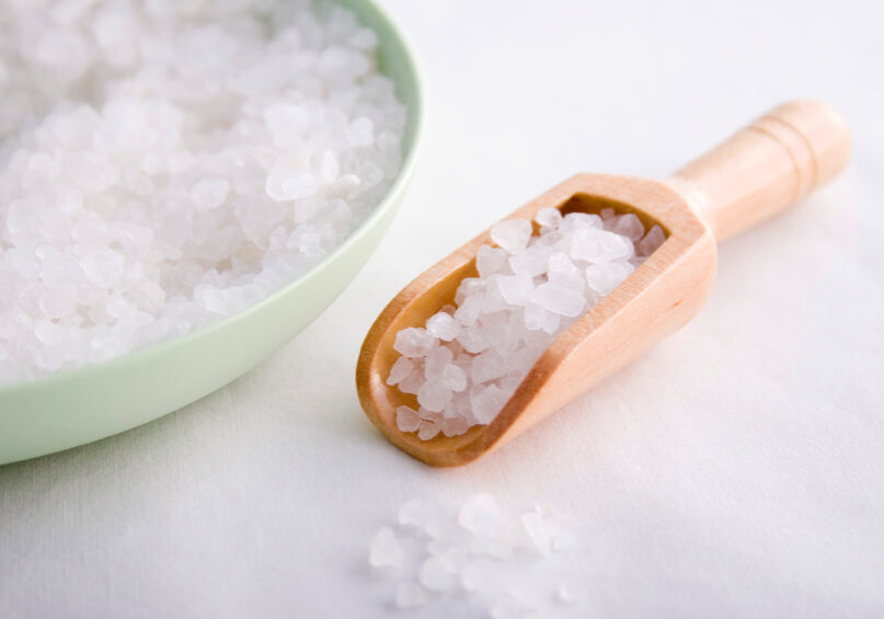 White bath salts in green bowl