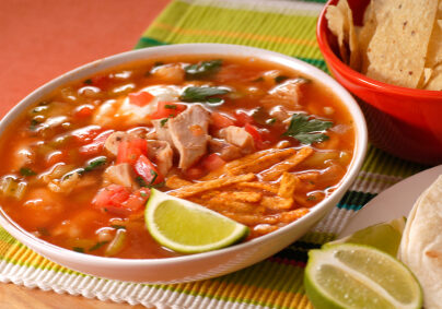 Bowl of chicken and tortilla soup with lime