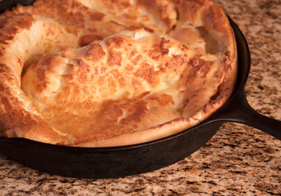 The Dutch Baby Pancake is also called a German Pancake. It's a sweet breakfast dish made from flour, milk, and eggs, baked in a cast iron skillet and served with powdered sugar and fresh lemon juice. Similar to Yorkshire Pudding.