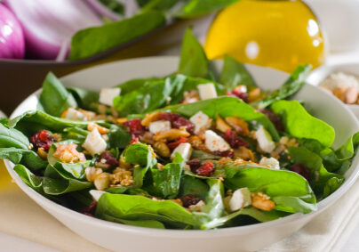 plate of fresh colorfull spinach salad close up