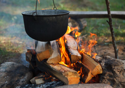 Preparing food on campfire in wild camping