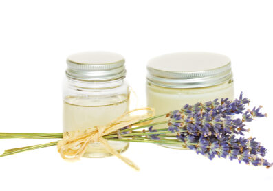 jars with cream and  dry lavender  isolated on white background