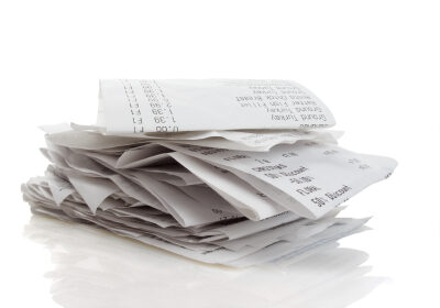 Stack of receipts piled high on white background